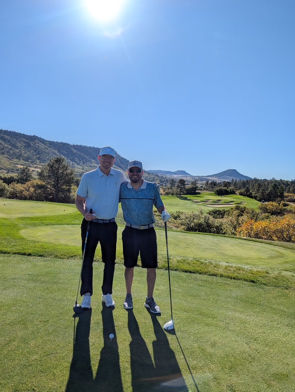 Ryan at Bear Dance golf course in Colorado with mountain backdrop.