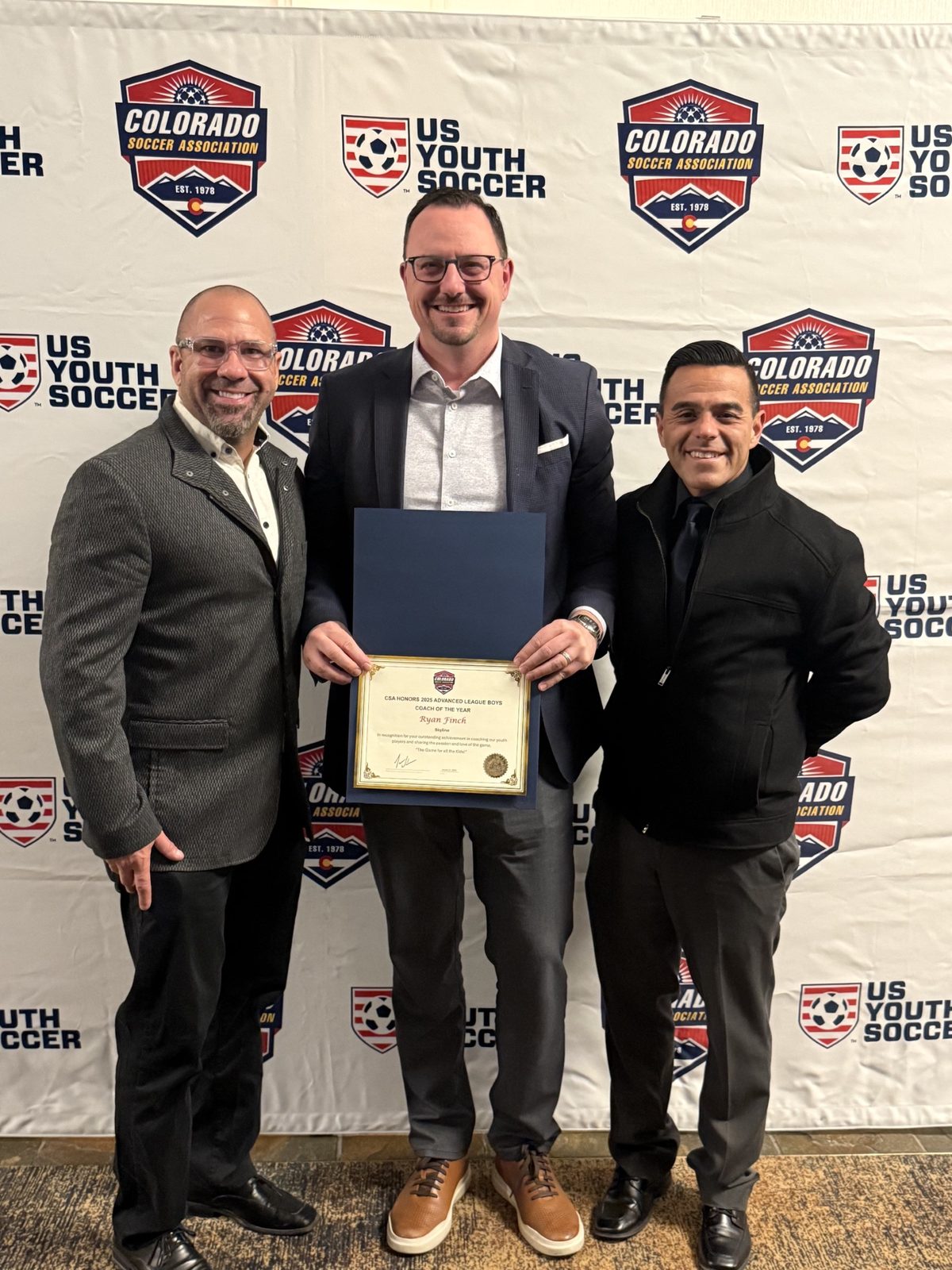 Ryan Finch receiving a Colorado Soccer Association coaching award.